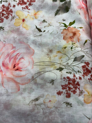 Floral patterned fabric with pink, yellow, and red flowers on a light background