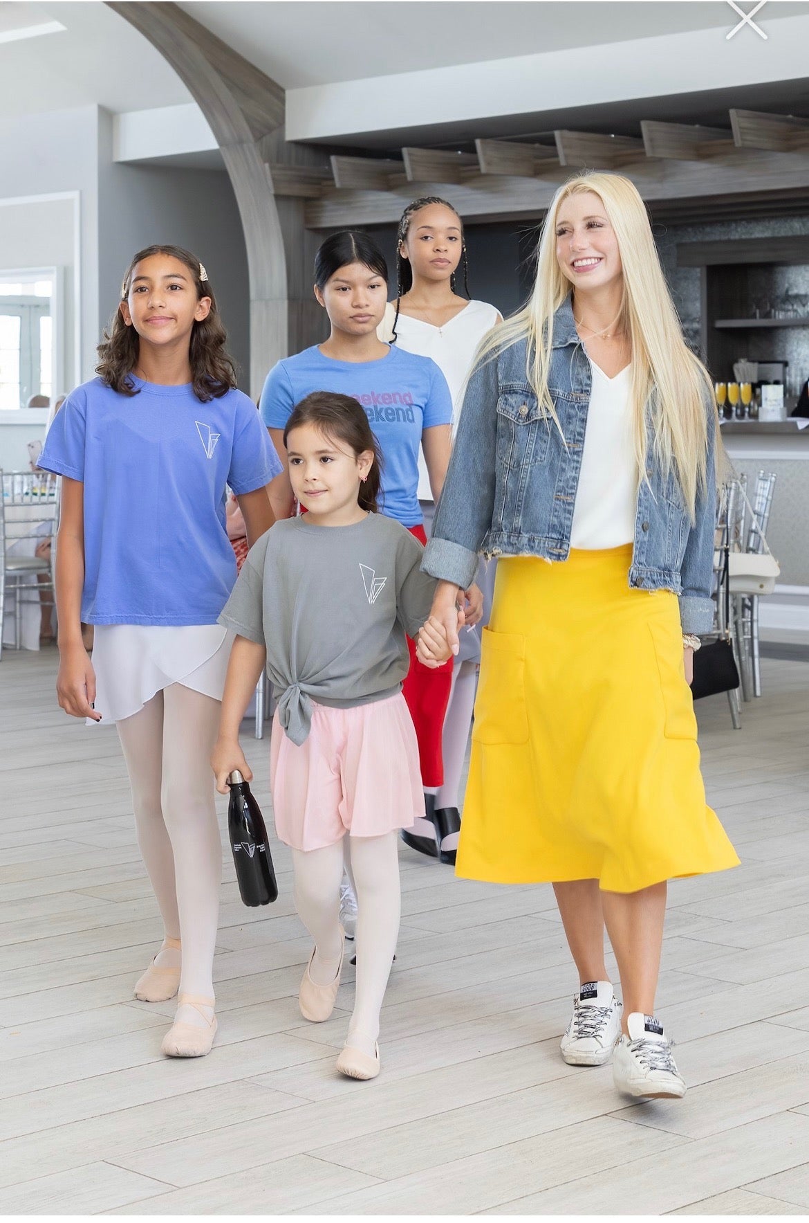 American Reportory ballet dancer wearing 1980s inspired jean jacket with yellow 2 pocket Mireille midi skirt at the &quot;September in Paris&quot; fashion show by Le Mireille Marche.
