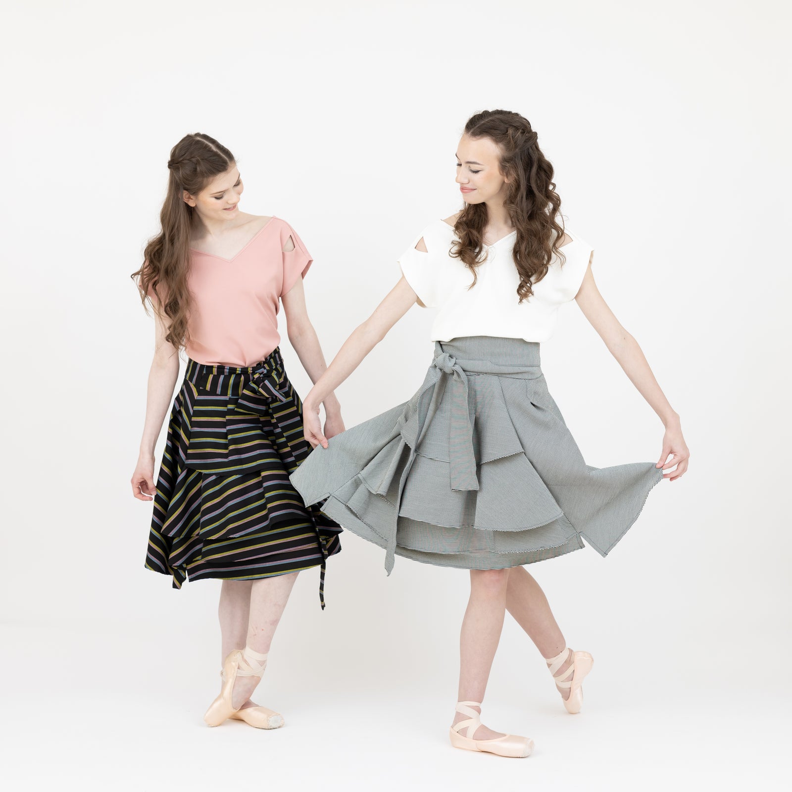 Two ballerinas wearing the Valerie wrap skirt and Julie V neck top.