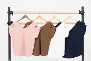 Ballet barre showcasing Julie the double V neck & back top by Le Mireille Marche in all four colours: rose/pink, French roast/brown, blanche/white, and marine/navy.